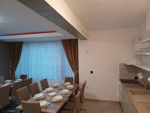 a dining room with a long table and chairs at MONADIN Villa Relax & Spa in Săcele