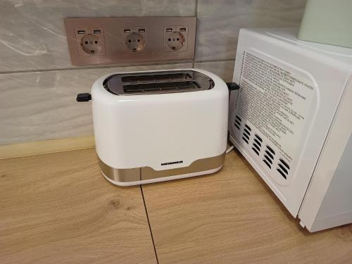 a toaster oven sitting next to a microwave at MONADIN Villa Relax & Spa in Săcele