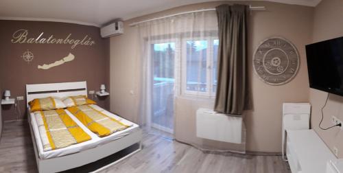 a bedroom with a bed with yellow pillows at Mórocz Vendégház in Balatonboglár