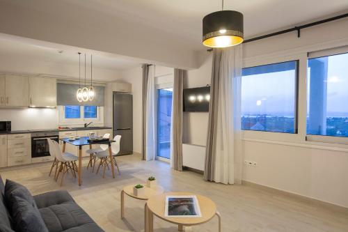 a living room with a couch and a table at Sea n' Smile in Apolpaina