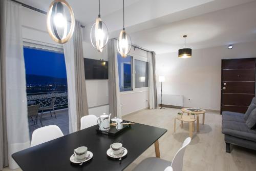 a living room with a black table and chairs at Sea n' Smile in Apolpaina