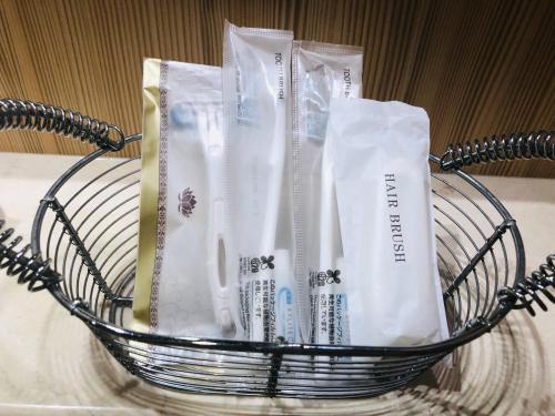 a basket filled with toothbrushes and toothpaste at Hotel Square FujiGotemba in Gotemba