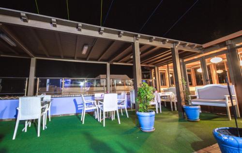 a group of white chairs and tables on a balcony at Hotel Tarek in Chefchaouene