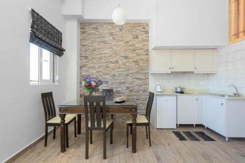 a kitchen and dining room with a table and chairs at Vlycha Beach Apartments in Lindos