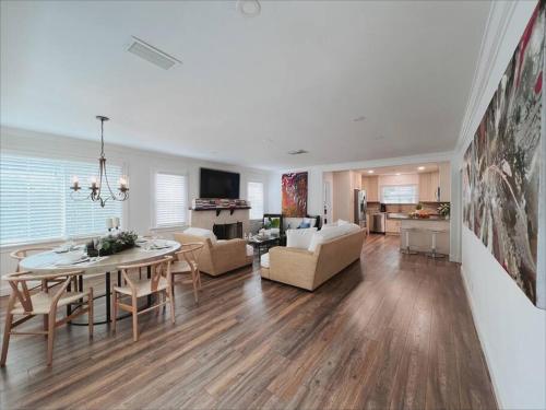 a living room with a table and a dining room at Beautiful Main House in West Palm Beach in West Palm Beach