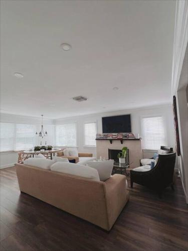 a living room with a couch and a fireplace at Beautiful Main House in West Palm Beach in West Palm Beach
