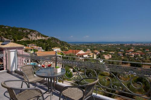 a balcony with a table and chairs and a view at Sea n' Smile in Apolpaina