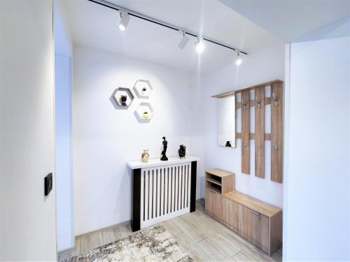 a hallway with white walls and a radiator at Cozy Apartment in Pristina in Pristina