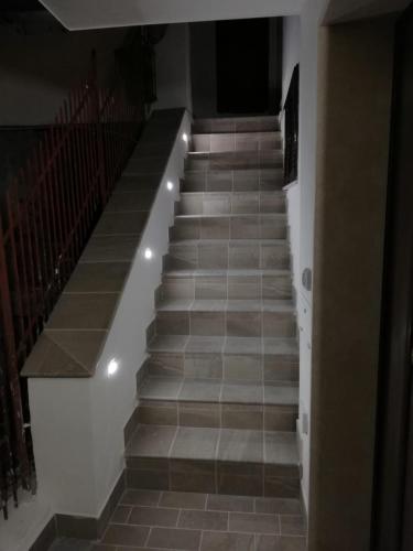 a staircase with brown tile floors and lights at Da Piero & Lilia in Centola