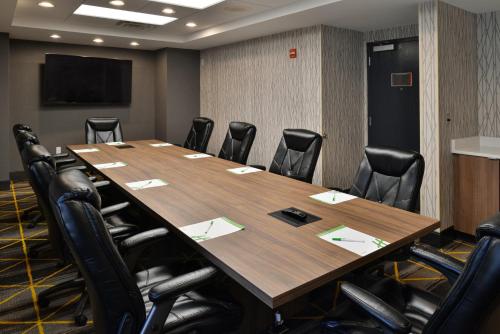 a conference room with a large wooden table and chairs at Holiday Inn Hotel & Suites Overland Park-Convention Center by IHG in Overland Park