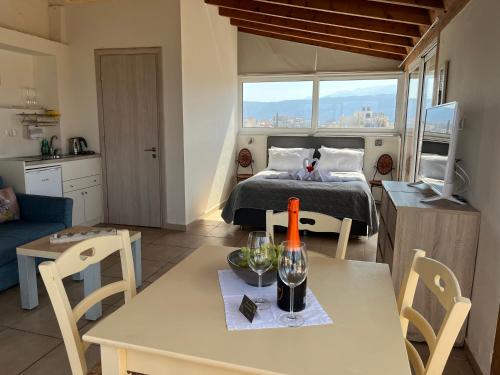 a living room with a bed and a table with a dining room at Candia Hotel in Chania Town