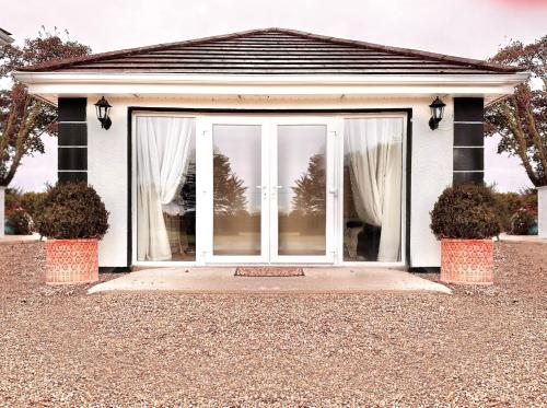 a large sliding glass door of a house at Long Acre Lodge in Murntown