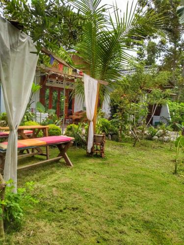 a picnic table in the yard of a house at Sumatra Orangutan Discovery Villa in Bukit Lawang