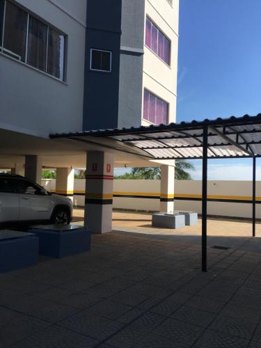 a car parked in a parking lot next to a building at Rio Quente - DiRoma in Rio Quente