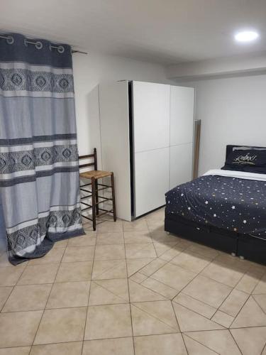 a bedroom with a bed and a tiled floor at Schöne Unterkunft mit Whirpool nahe Phantasialand in Weilerswist