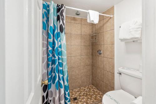 a bathroom with a shower and a toilet at Inn at Palm Springs in Palm Springs