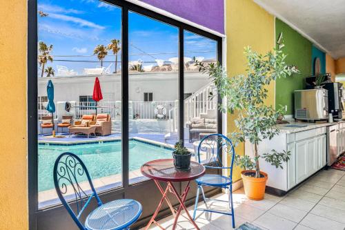 a patio with a table and chairs and a pool at Inn at Palm Springs in Palm Springs