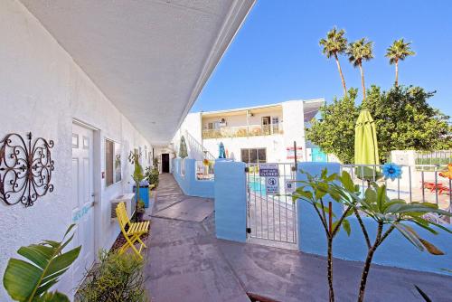 a balcony of a house with a fence and palm trees at Inn at Palm Springs in Palm Springs