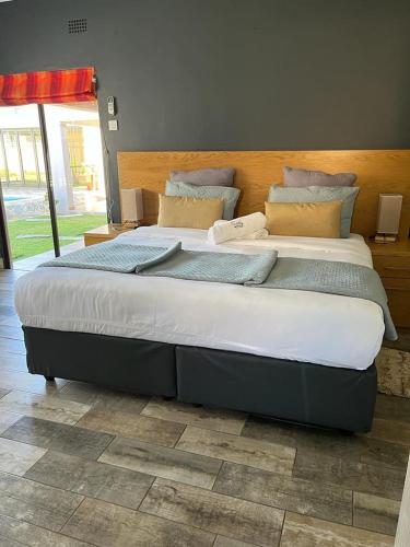 a large bed sitting in a room with at Homey Guesthouse in Gaborone