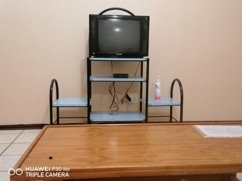 a tv sitting on a stand with a table at Kingsview 201 in Margate