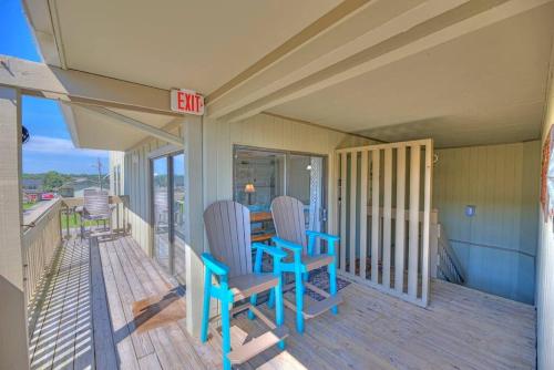 a porch with two chairs and a table on it at Living the Dream 2 Bedroom Ocean View Cozy Condo in Gulf Shores