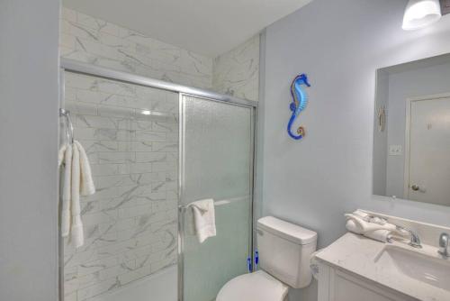 a bathroom with a shower and a toilet and a sink at Living the Dream 2 Bedroom Ocean View Cozy Condo in Gulf Shores