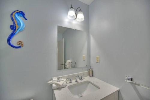 a bathroom with a sink and a mirror at Living the Dream 2 Bedroom Ocean View Cozy Condo in Gulf Shores