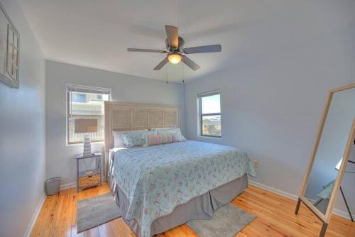 a bedroom with a bed and a ceiling fan at Living the Dream 2 Bedroom Ocean View Cozy Condo in Gulf Shores