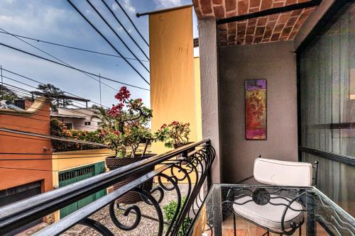 a balcony with a table and a chair at Casa del Sol Inn in Ajijic
