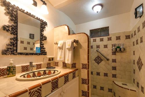a bathroom with a sink and a mirror at Casa del Sol Inn in Ajijic