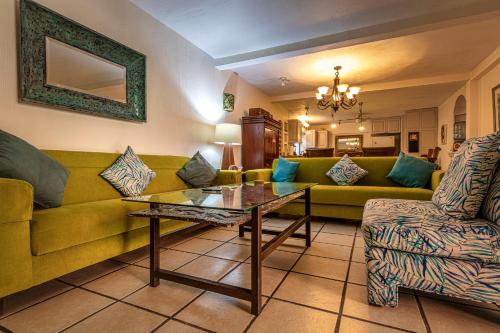 a living room with a couch and a table at Casa del Sol Inn in Ajijic