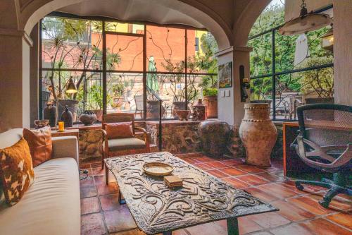 a living room with a couch and a table at Casa del Sol Inn in Ajijic