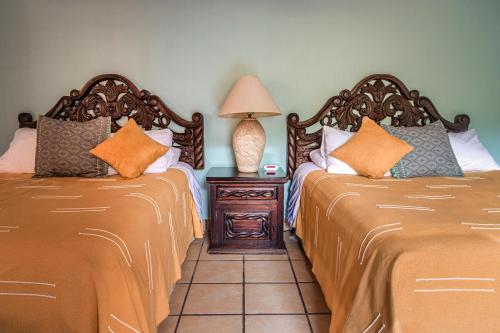two beds sitting next to each other in a room at Casa del Sol Inn in Ajijic