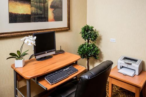 an office with a desk with a computer and a printer at Days Inn by Wyndham Edmonton Downtown in Edmonton
