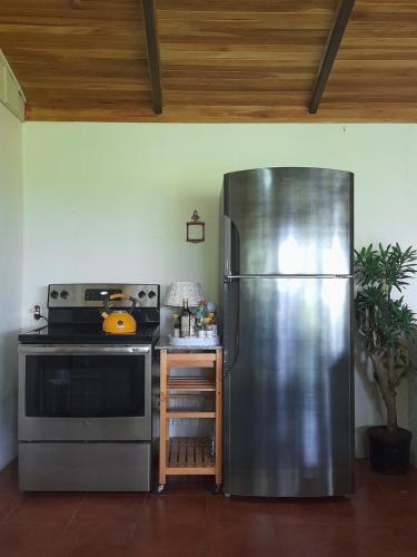 a kitchen with a stainless steel refrigerator and a stove at Casa Zu in San Pedro