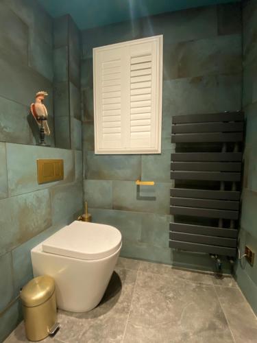 a bathroom with a white toilet and a staircase at Ailim House Serviced Cottage Escape, around the corner from the Old Course in St. Andrews