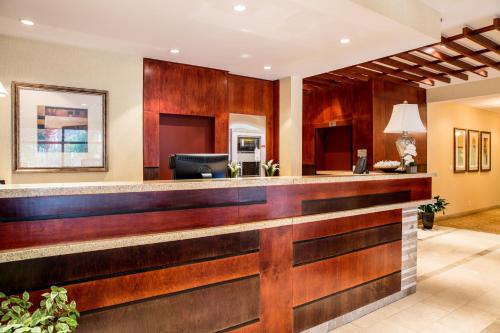 a bar in a hotel lobby with wood paneling at Days Inn by Wyndham Edmonton Downtown in Edmonton
