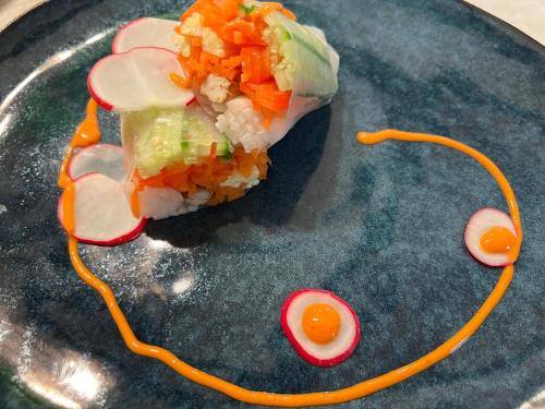 a plate of food with sushi and an egg on it at Ailim House Serviced Cottage Escape, around the corner from the Old Course in St. Andrews