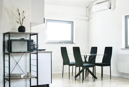 a dining room with a table and chairs and a tv at The Manhattan A Boutique Hotel By American Ease in Gravenwerth