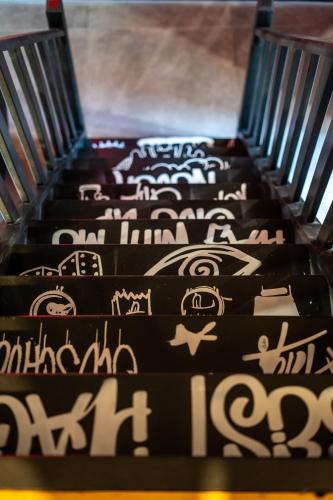 an escalator with many different signs on it at Capsule Art Déco - Jacuzzi - Netflix - Home Cinéma - Arcade de jeux & Nintendo switch - 2 chambres - Filet suspendu in Valenciennes