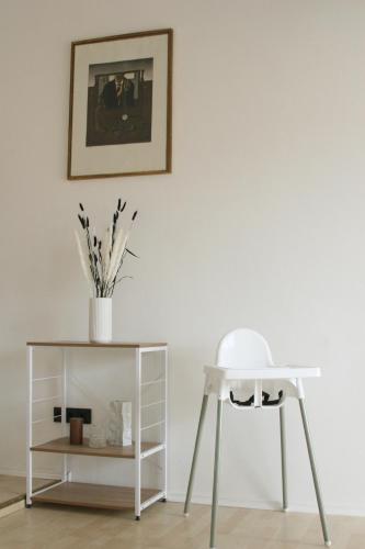 a white stool next to a table and a chair at The Manhattan A Boutique Hotel By American Ease in Gravenwerth