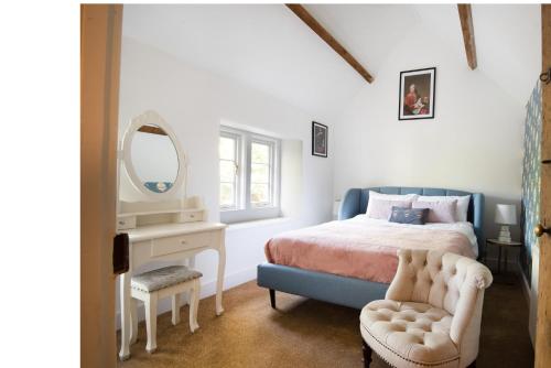 a bedroom with a bed and a mirror and a chair at Dream Stays Bath - Southbank, EVC Parking in Bath