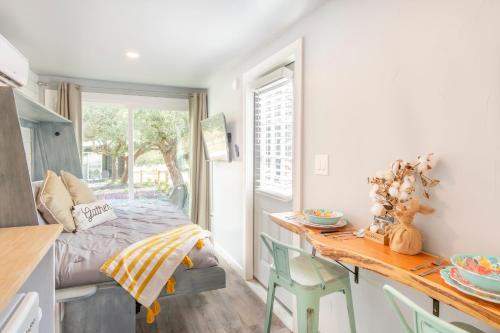 a small bedroom with a bed and a table and chairs at The Container Retreat at 290 Wine Trail #2 Adventure awaits! in Hye