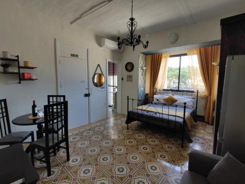 a bedroom with a bed and a table and a window at Near Valletta City - Open Views - Ta Tessie Suite in Floriana - Malta in Il-Furjana