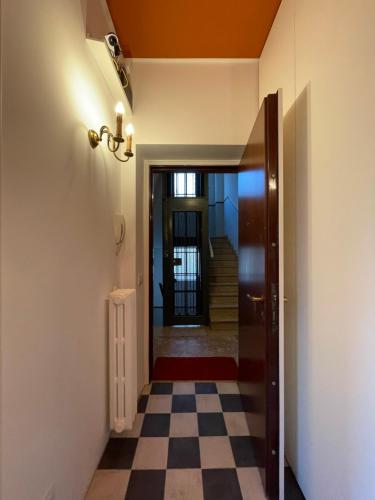 a hallway with a door and a checkered floor at La Marina di Milano - Pier Lombardo in Milan