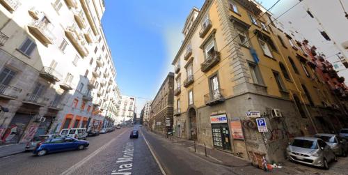 a city street with cars parked on the sides of buildings at Monteoliveto 5 in Naples