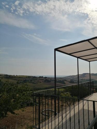 a balcony with a view of the rolling hills at La Sperella Bed and Breakfast in Fermo