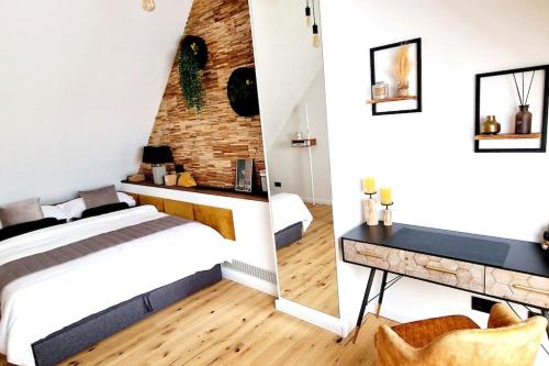 a bedroom with a bed and a brick wall at Stilvolle Maisonette Wohnung in Karlsruhe