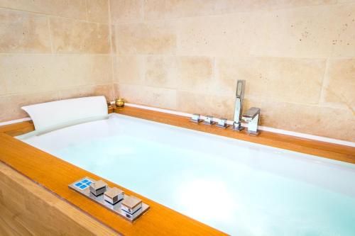 y baño con bañera y lavamanos. en Jacuzzi® - La petite Romantique - FloBNB en Laon