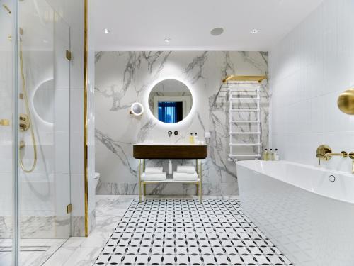 a bathroom with a sink and a mirror at Hotel Altus Palace - Destigo Hotels in Wrocław